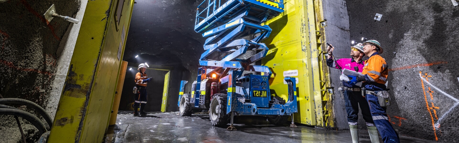 Redpath employees deep underground, making observations and having discussions about their work environment surroundings.