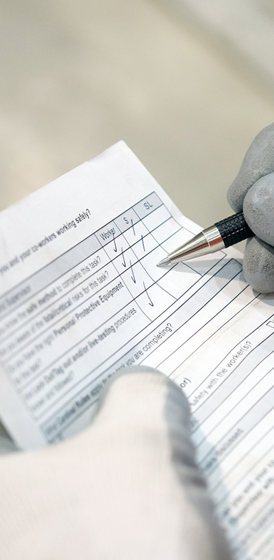 A Redpath employee completing a five-point safety card.